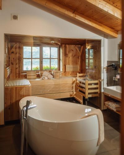 a large bathroom with a tub and a sink at Berg- & Seeblick Pfefferbauer in Zell am See