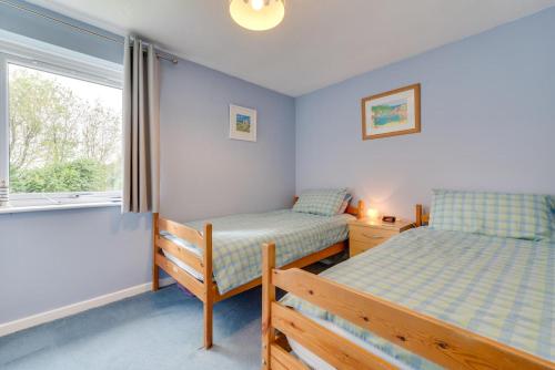 a bedroom with two beds and a window at 2 Bed in Penzance oc-pc467 in Gulval