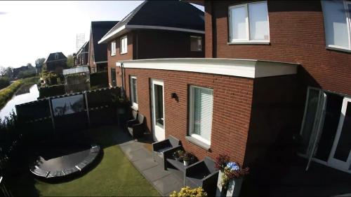 an aerial view of a brick house with a garage at Private apartment with garden, close to Amsterdam in Assendelft