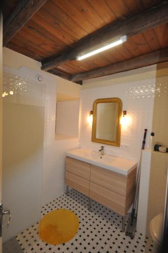 a bathroom with a sink and a mirror at Chez Gérard in Saint-Martin-Lars-en-Sainte-Hermine