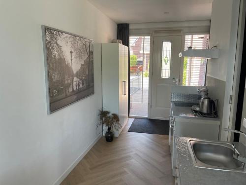 a kitchen with a sink and a counter top at Private apartment with garden, close to Amsterdam in Assendelft
