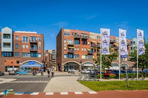a group of flags in front of a building at Private apartment with garden, close to Amsterdam in Assendelft