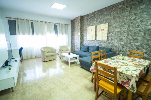 a living room with a blue couch and a table at Edificio Prieto VIV 2E in Puerto del Rosario