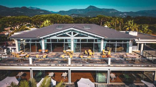 a house with a deck with tables and chairs at Hotel & Restaurant San Pellegrino in Folelli