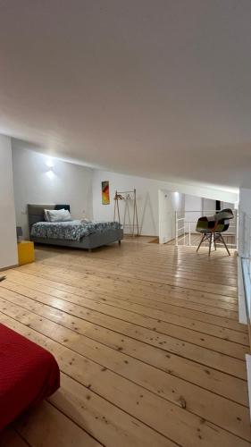 a large room with a bed and a wooden floor at Villa Laura in Cefalù