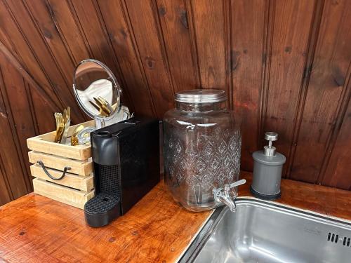 a counter top with a jar on top of a sink at Igloo-Dome by a River - Sky Sighting - Glamping in Litli-Árskógssandur
