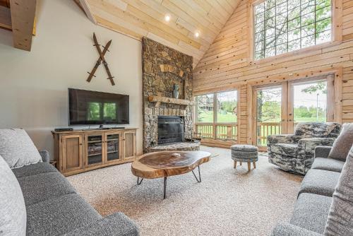 a living room with a fireplace and a tv at Alpine Adventure in McHenry