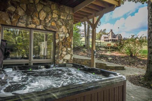 a hot tub in front of a stone building at Alpine Adventure in McHenry