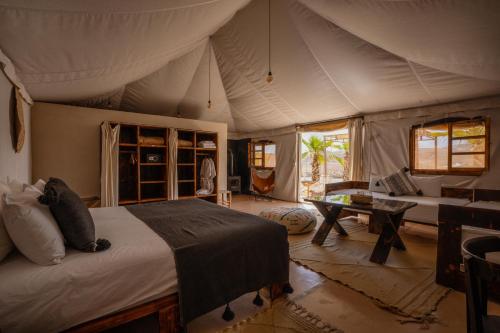 a bedroom with a bed in a tent at Oxygen Lodge Agafay in El Karia