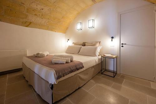 a bedroom with a large bed in a room at Janela Blue Civico 35 in Otranto