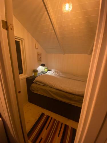 a bedroom with a bed in a small room at Huset ved stranden in Nykøbing Sjælland