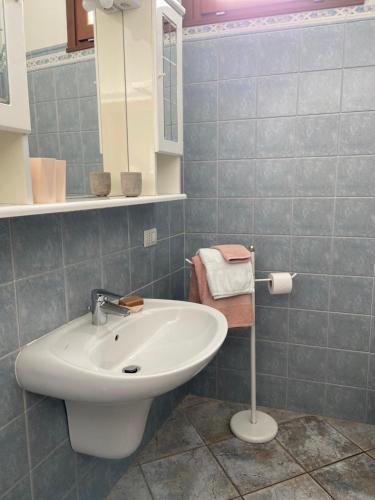 a bathroom with a white sink and a mirror at Appartamento sole in Vercana