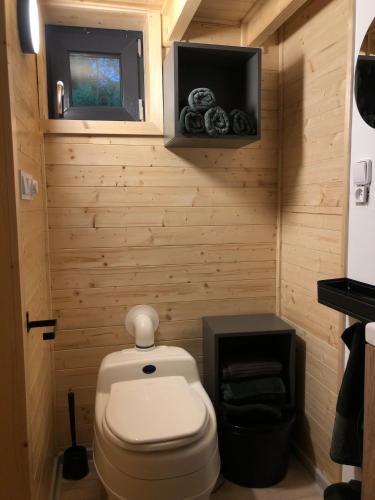 a small bathroom with a toilet and a tv at Tiny House na pevnosti Křelov in Olomouc