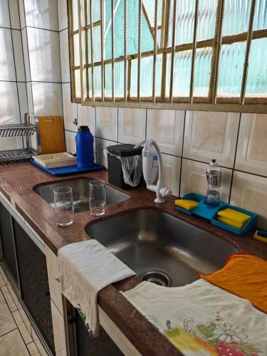 a kitchen with a sink and a counter top at Sereny Stone Palace in Rondonópolis