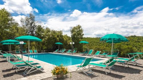 a swimming pool with chairs and umbrellas at Tenuta della Selva - Castellaccio 7 in Murlo