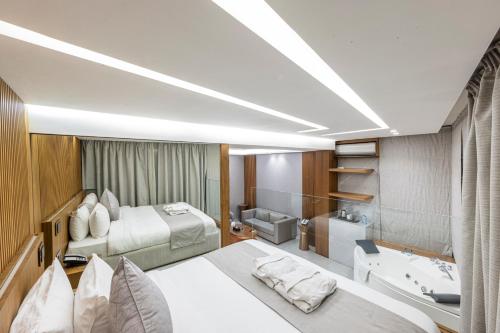a bedroom with two beds and a bathroom with a sink at Heaven Prestige Hotel in Jounieh