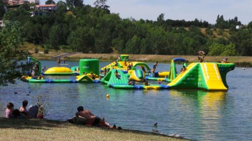 a group of inflatable slides in the water at ZEcamping 3 dog friendly avec piscine au bord du lac de la Thésauque in Nailloux