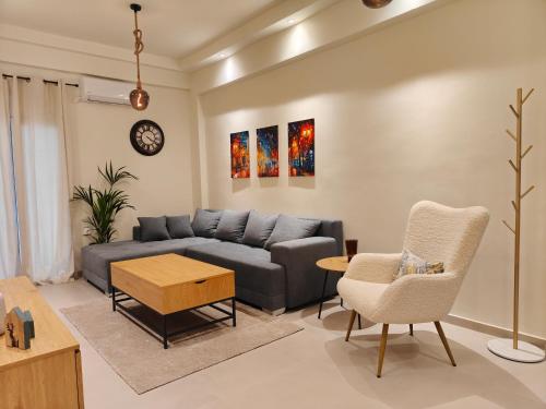 a living room with a couch and a table at Your Inn in Tríkala
