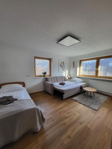 a living room with two beds and a couch at Ferienwohnung Pöll in Stanz bei Landeck