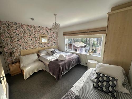 a bedroom with a bed and a window at Station Approach Solihull Cabin Stays in Solihull