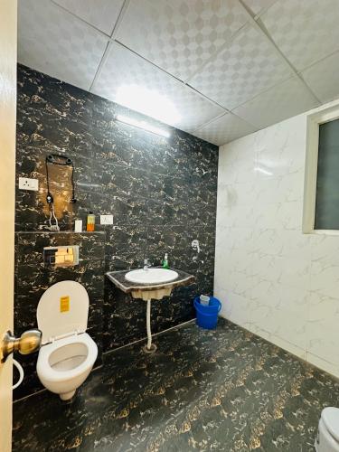 a bathroom with a toilet and a sink at Dream heaven in Greater Noida