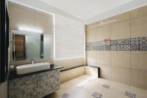 a bathroom with a sink and a mirror at Aroha luxury homestay in Madikeri