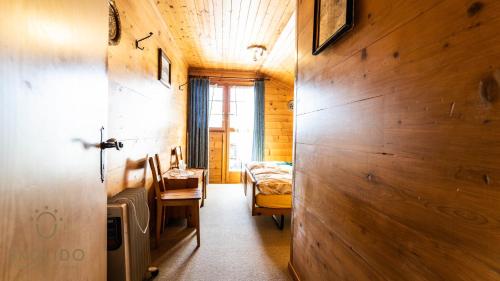 a bedroom with a desk and a bed in a room at Haus Chämihitta, Riederalp Moosfluh in Riederalp