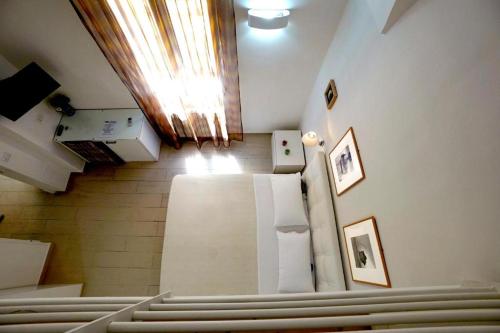 a room with a row of pews in a church at Elamar Apartments in Gallipoli