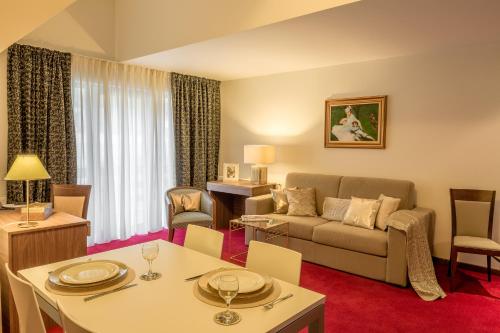 a living room with a couch and a table at Hotel Boutique Belvedere in Sinaia