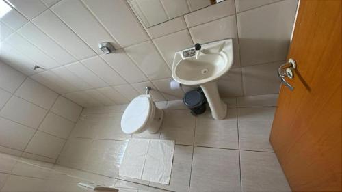 a bathroom with a sink and a toilet at Hotel Universo in Goiânia