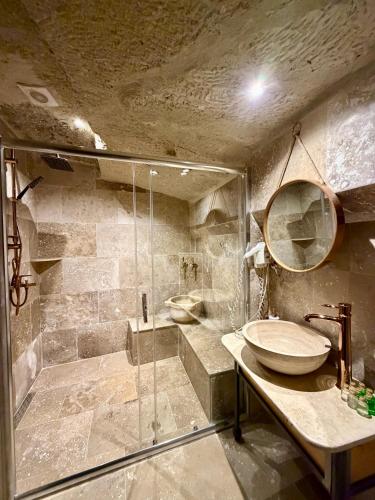 a bathroom with a sink and a shower at Century Cave Hotel in Göreme