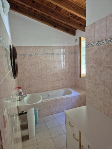 a bathroom with a sink and a bath tub at MAISON TUCCARELLU in Letia