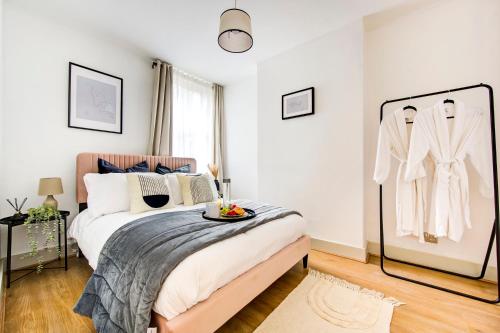 a bedroom with a bed with a tray of fruit on it at East London 2 bedrooms flat in London