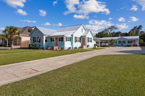 a house on a street with a driveway at Honeymoon Suite with Shared POOL in Bay Saint Louis