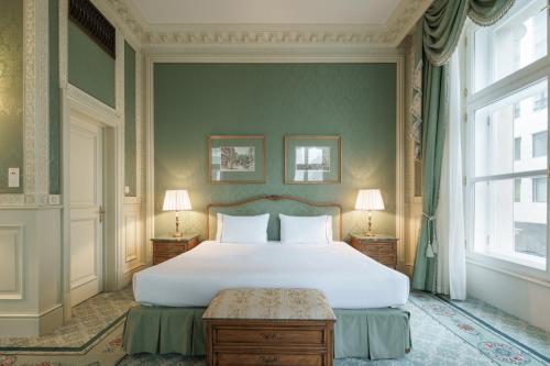 a bedroom with a large white bed and a window at Eurostars Grand Hotel Wien in Vienna