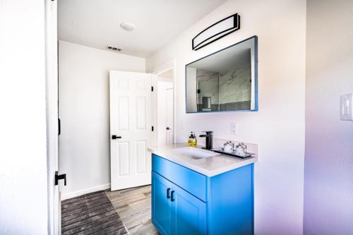 a bathroom with a blue sink and a mirror at 6 Bedroom, 3 unit Triplex in Crystal Beach in Port Bolivar
