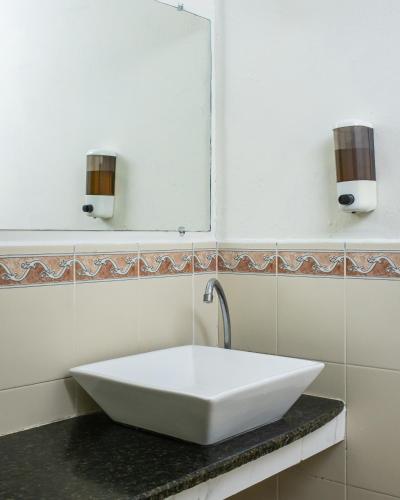 a white sink in a bathroom with a mirror at Hotel Pablo Tesák in San Vicente