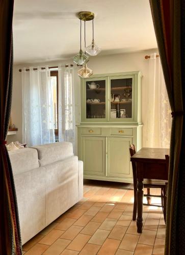 a living room with a couch and a cabinet at Casa dei nonni in Rigali