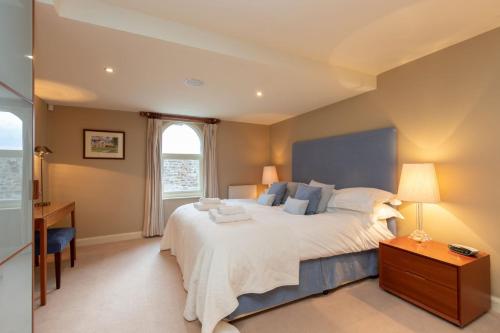 a bedroom with a large bed and a window at Underscar - Luxury 3 Bed Apartment in Applethwaite