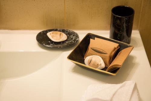 a box with two balls in it next to a plate at Hotel Boutique Belvedere in Sinaia
