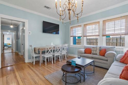 a living room with a couch and a table at The Anchor Once Upon A Tide Villas POOL in Bay Saint Louis