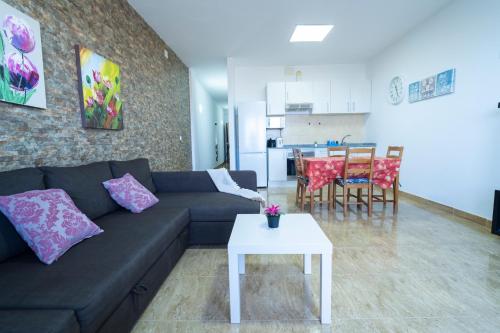 a living room with a couch and a table at Edificio Prieto Vivienda 2D in Puerto del Rosario