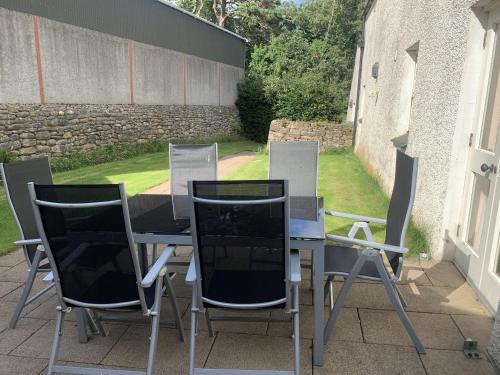 a table and four chairs sitting on a patio at The Stable, Magheramore Courtyard in Dungiven