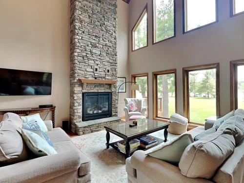a living room with two couches and a fireplace at Paravel in Swanton