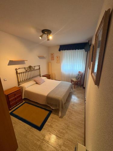 a bedroom with a bed and a chair in it at Apartamento La Ojerada in Ajo