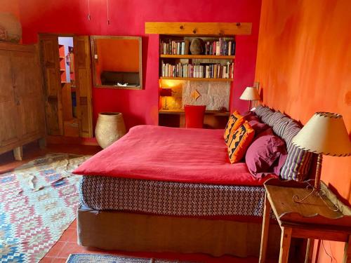 a bedroom with red walls and a bed with red sheets at Posada de la Cruz#5 in Querétaro