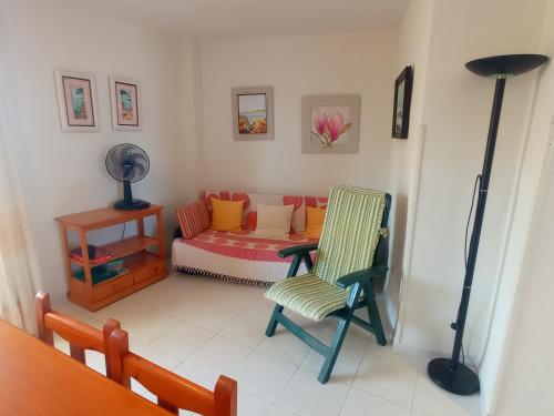 a living room with a chair and a couch at Les Motes Solo Familias Serviplaya!!! in Playa de Xeraco