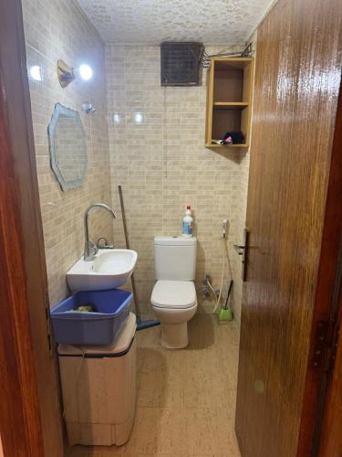 a small bathroom with a toilet and a sink at باليمرا in Ain Sokhna