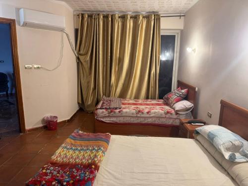 a living room with two beds and a window at باليمرا in Ain Sokhna