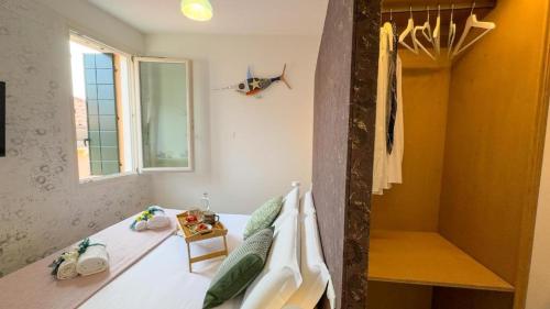 a bedroom with a bed and a window at Cà De La Corona EXPERIENCE in Chioggia